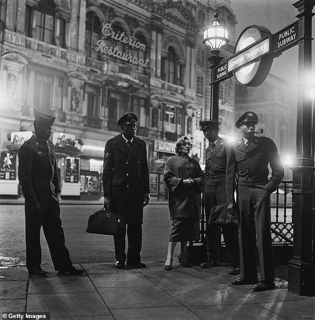 American troops and a friend waiting at Piccadilly Circus Station for the first train home after leaving the Club Americana jazz club in London, November 25th 1955