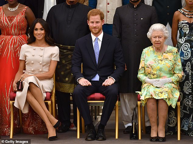 The Queen (pictured with Harry and Meghan in 2018) allegedly remained 'adamant' that the Sussexes 'must be stripped of their patronages and banned from using their HRH titles personally and commercially'