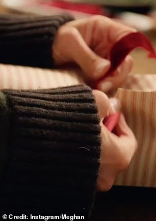 Meghan can be seen wrapping gifts
