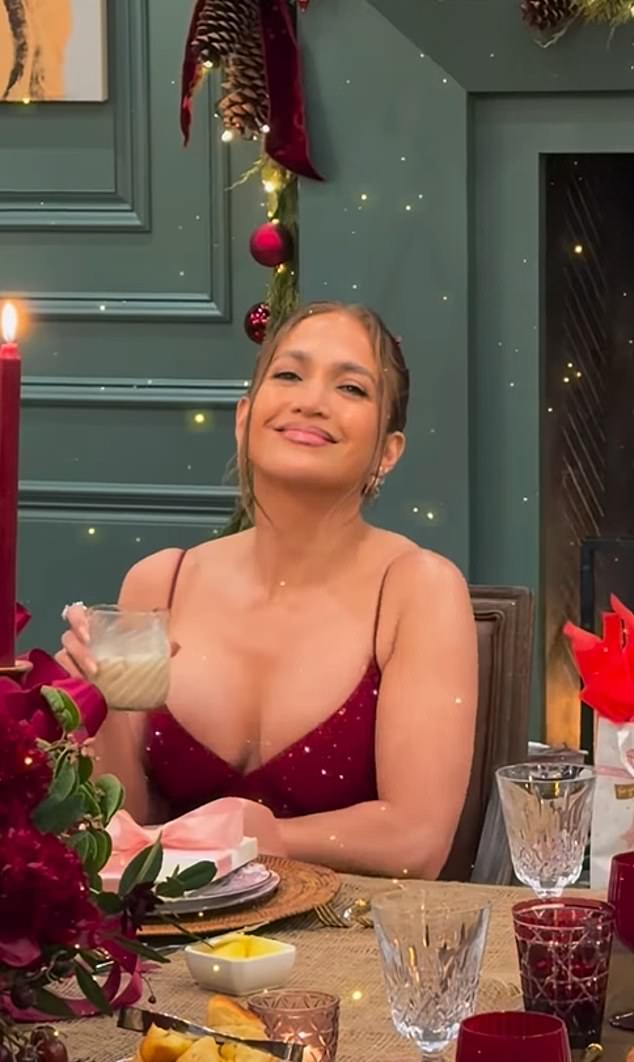The table was decorated with blood-red candles, stacked trays full of grapes and plates decorated with pink bows, yet Jennifer looked totally at ease as she sipped on what looked like a glass of eggnog
