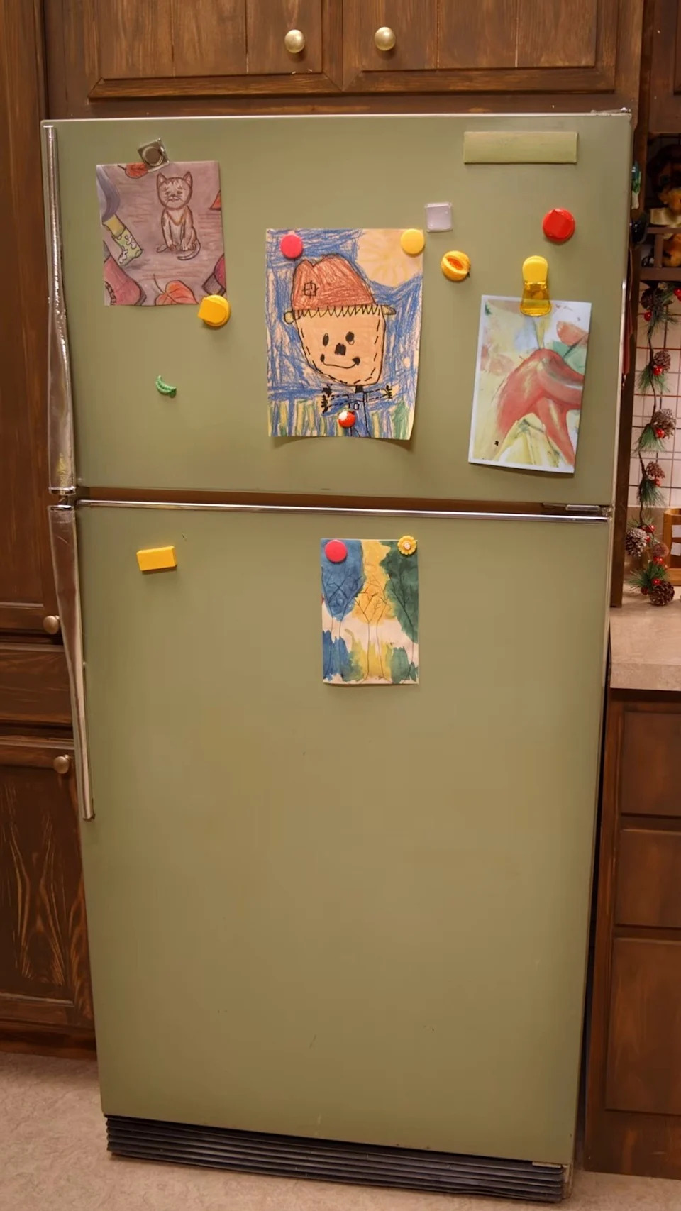 The kitchen boasted a large wooden table, matching wooden cabinets, yellow oven, granite countertops, drawings, and a yellow KitchenAid mixer. <span class="image-credit">(Instagram)</span>