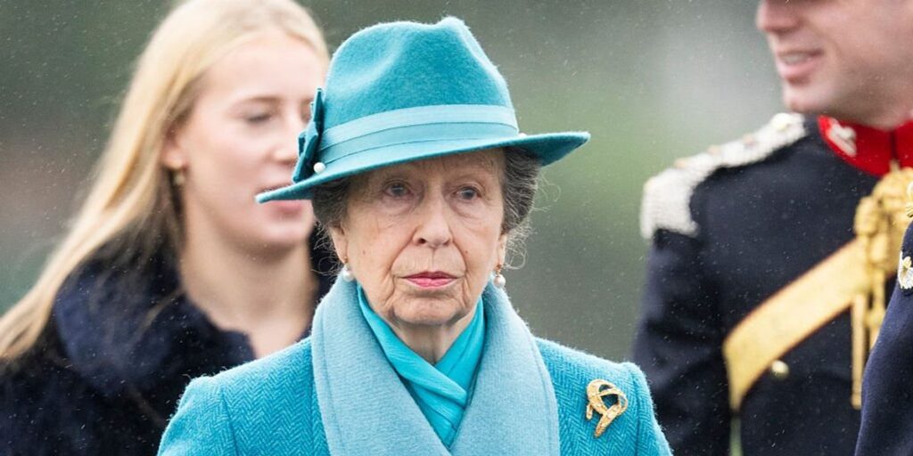 Princess Anne braces wet and windy weather as she represents King Charles