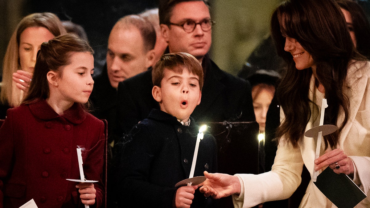 Kate Middleton watching Prince Louis blow a candle.