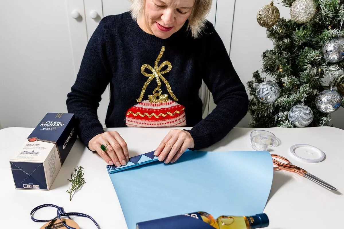 Jane Means wrapping a present
