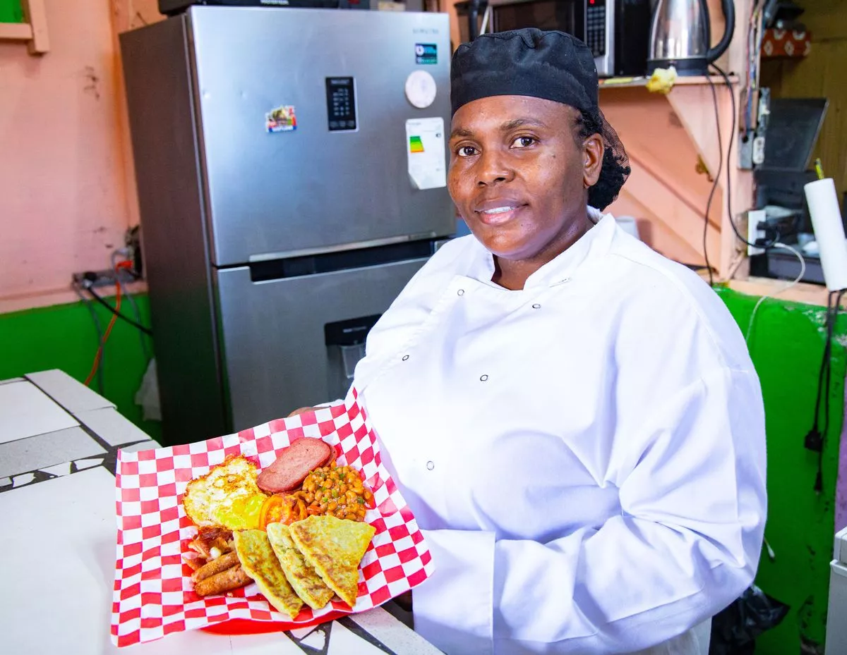 Tanisha Higgins serves up potato scones on a Scottish breakfast at her cafe in Kingston, Jamaica 