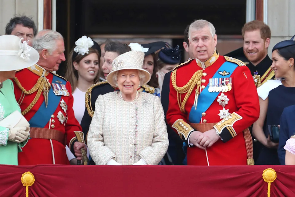 Prince Andrew, Queen Elizabeth and King Charles on the balcony of Buckingham Palace with Harry and Meghan standing behind them