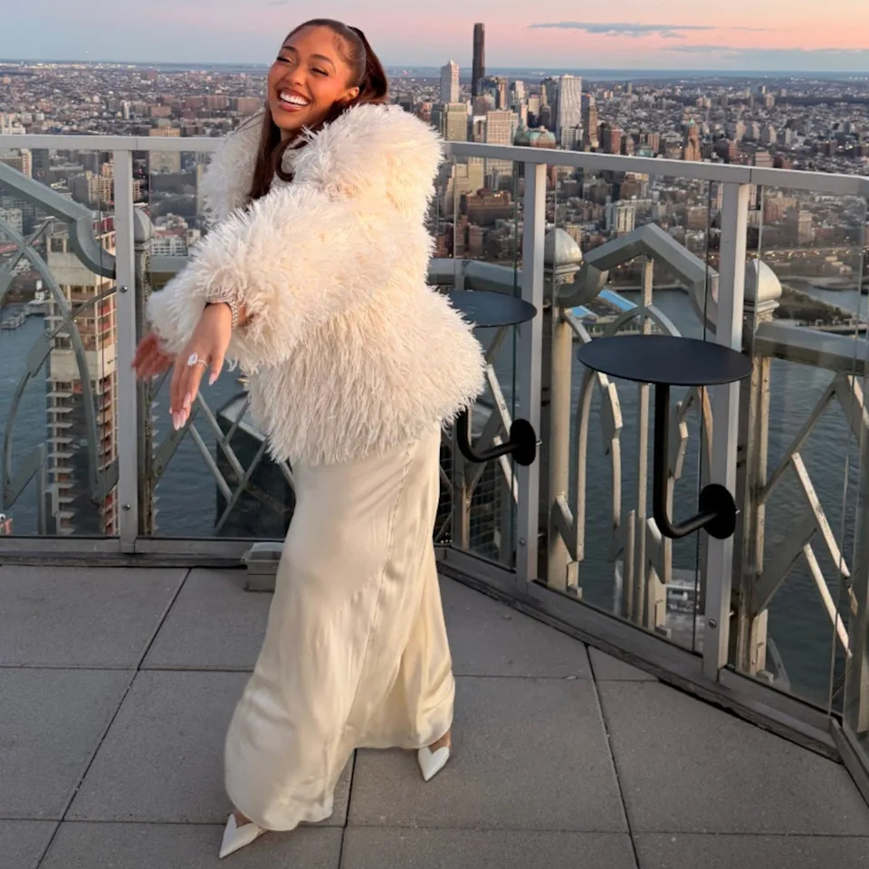 The couple, who have been dating for five years, announced their engagement on Dec. 25 in a joint Instagram post, in which Woods donned a white dress with a white fur coat, while Towns opted for a suede coat and black pants. <span class="image-credit">(Instagram)</span>