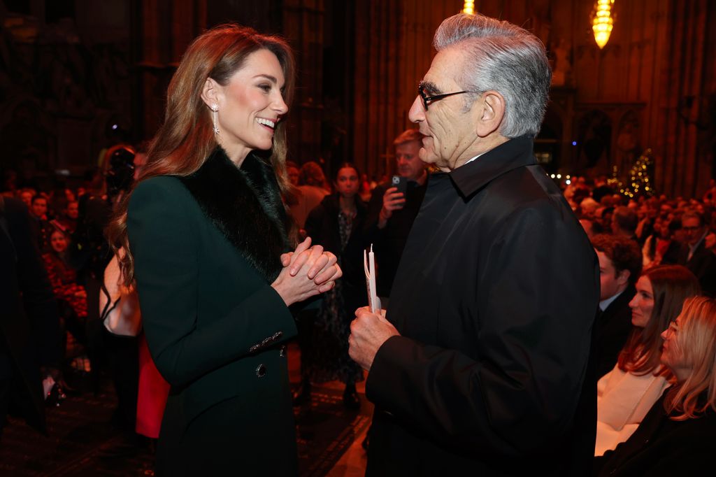 Catherine, Princess of Wales speaks with Eugene Levy at the 'Together At Christmas' Carol Service 
