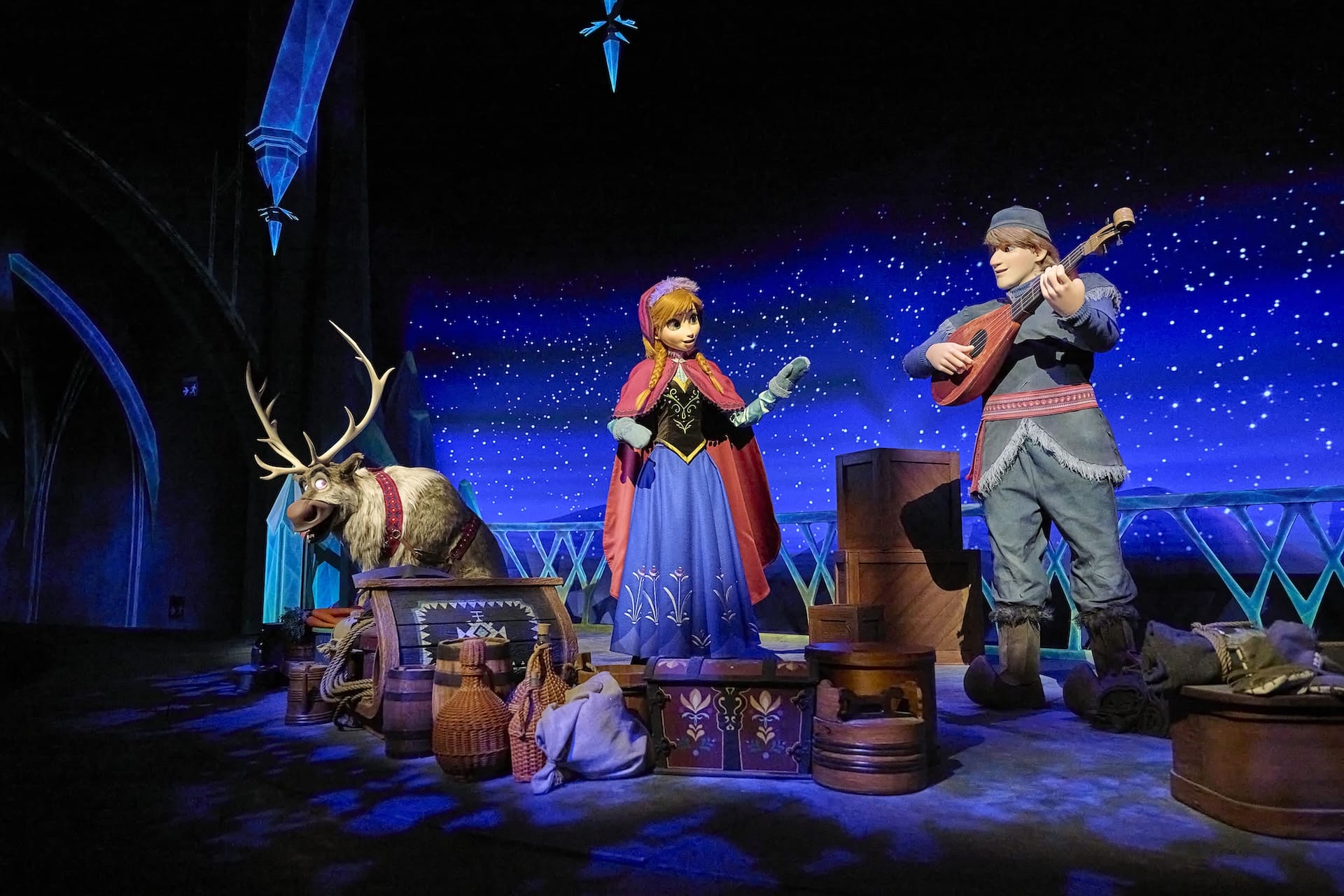 Anna, Kristoff, and Sven from Frozen Ever After on EPCOT’s stage, set with twinkling stars—no castle like Disney parks’ iconic spires.