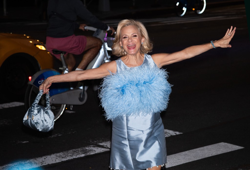 Amy Sedaris attending the New York City Ballet 2025 Fall Fashion Gala, wearing a light blue satin gown with a feathered bust and a matching handbag.