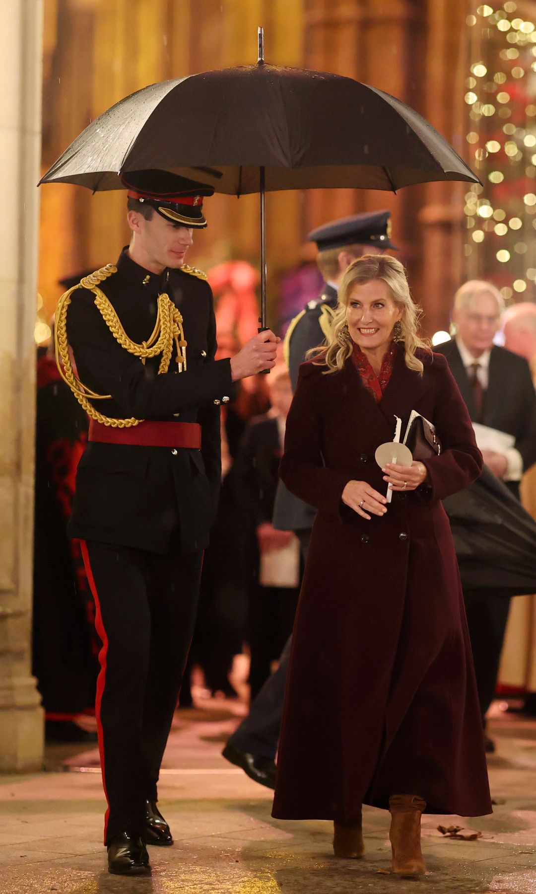 Duchess Sophie walking underneath an umbrella