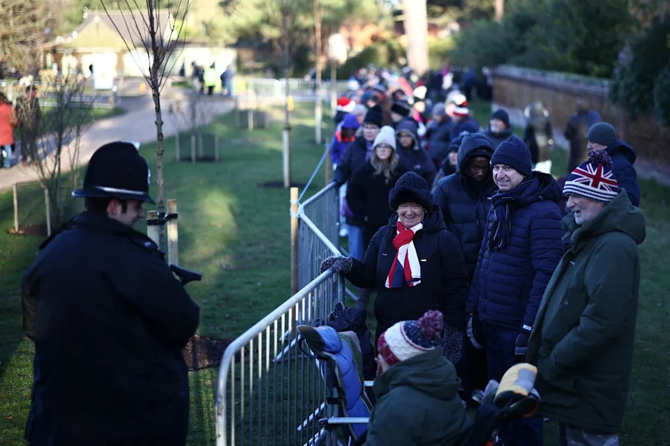 Well-wishers wait for members of Britain's Royal Family to arrive to attend the traditional Christmas Day service at St Mary Magdalene Church (AFP via Getty Images)