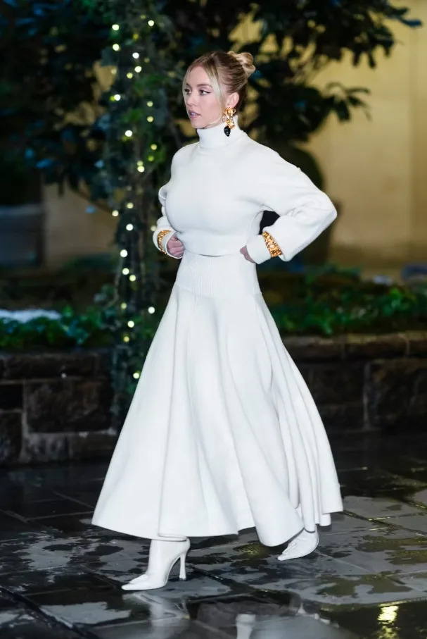 Sydney Sweeney wearing an all-white knit set with gold accessories in New York