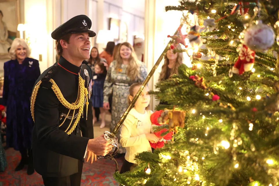 Chris Jackson/Getty Major Ollie Plunket decorates a Christmas tree at Clarence House on Dec. 12, 2024.