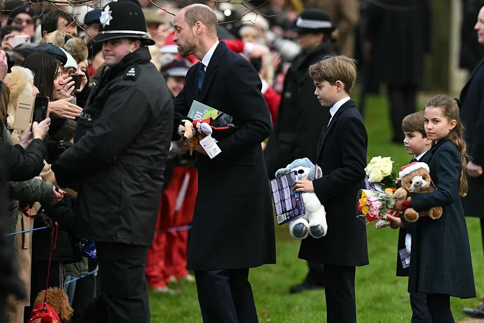 OLI SCARFF/AFP via Getty From left: Prince William, Prince George, Prince Louis and Princess Charlotte greet well-wishers at Sandringham on Dec. 25, 2024.