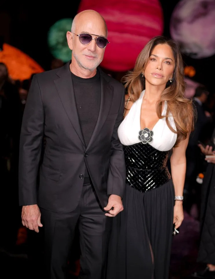 Getty Images Jeff Bezos with Lauren Sánchez Bezos on October 6, 2025.