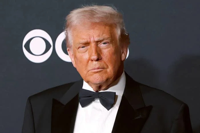 Person in a tuxedo with a bow tie at a formal event