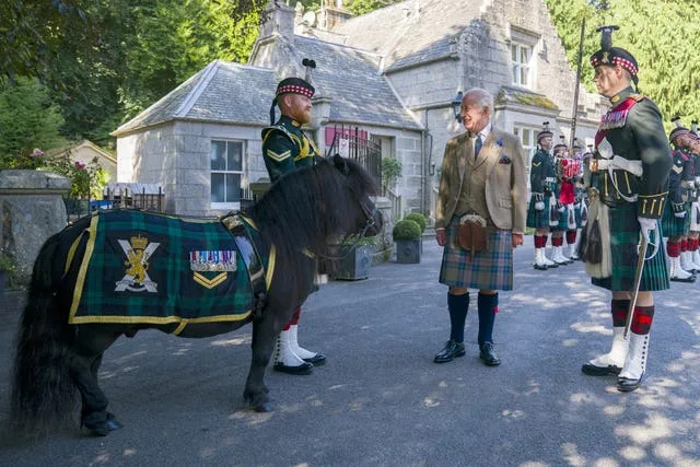 Charles inspecting the Balaklava Company, 5th Battalion, The Royal Regiment of Scotland, and greeting their mascot, Shetland pony Corporal Cruachan IV