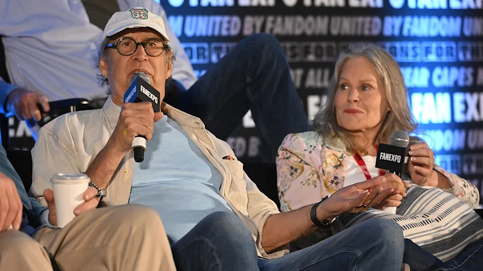 Beverly D'Angelo looking at Chevy Chase as he speaks.