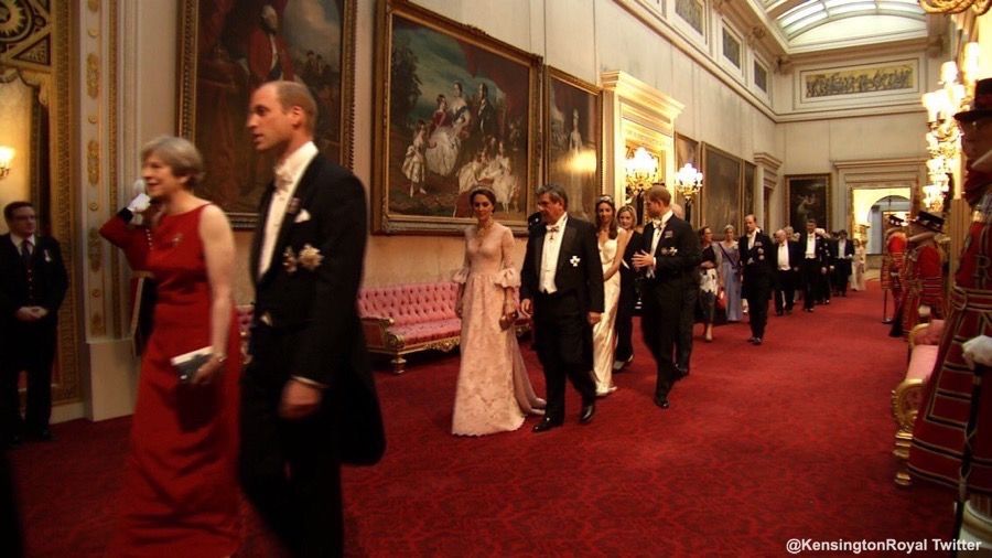 kate and others entering hall at buckingham palace in formal dress