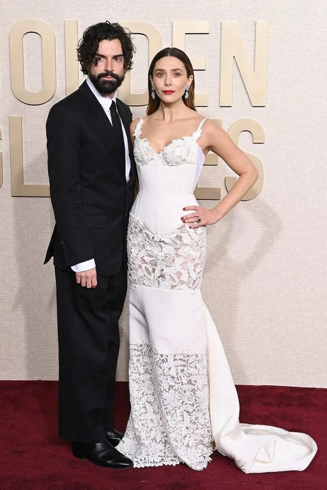 Jon Kopaloff/WireImage Elizabeth Olsen and husband Robbie Arnett.