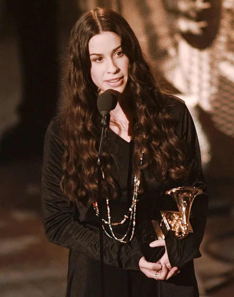 AP Photo/Eric Draper Alanis Morissette accepting her album of the year Grammy in 1996.