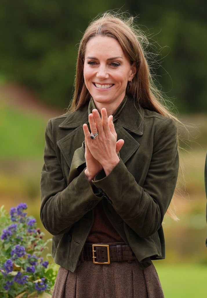 Catherine, Princess of Wales clapping outside in green jacket