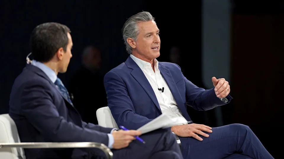 Gavin Newsom speaks on stage at the DealBook Summit