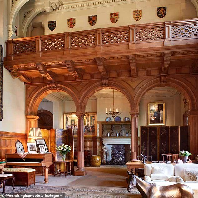 The impressive saloon, located at the entrance to the nineteenth century house, spans two floors and is complete with a wooden dining table, detailed tapestries, cream sofas, and a piano