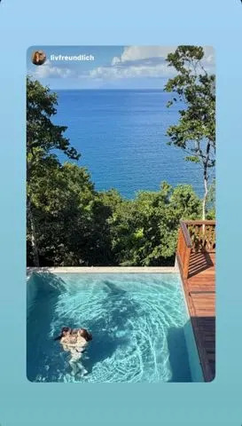 Instagram/Julianne Moore Julianne Moore wearing a black bikini with her daughter Liv while swimming