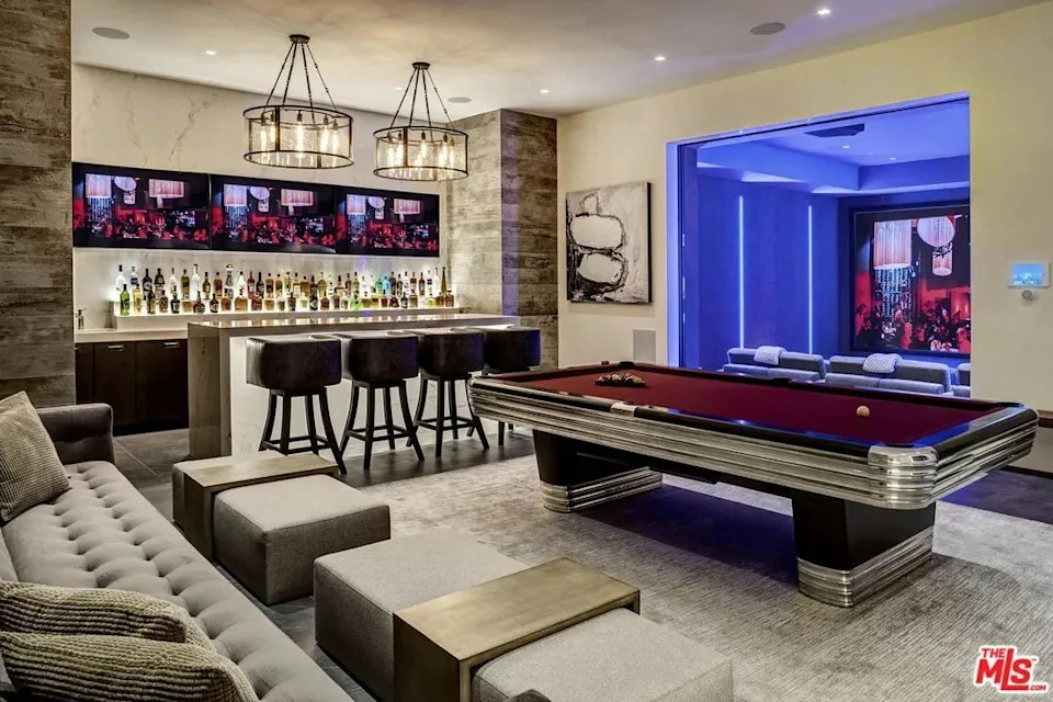 A bar and pool table outside of a moview theatre at Kylie Jenner's California home in Holmby Hills