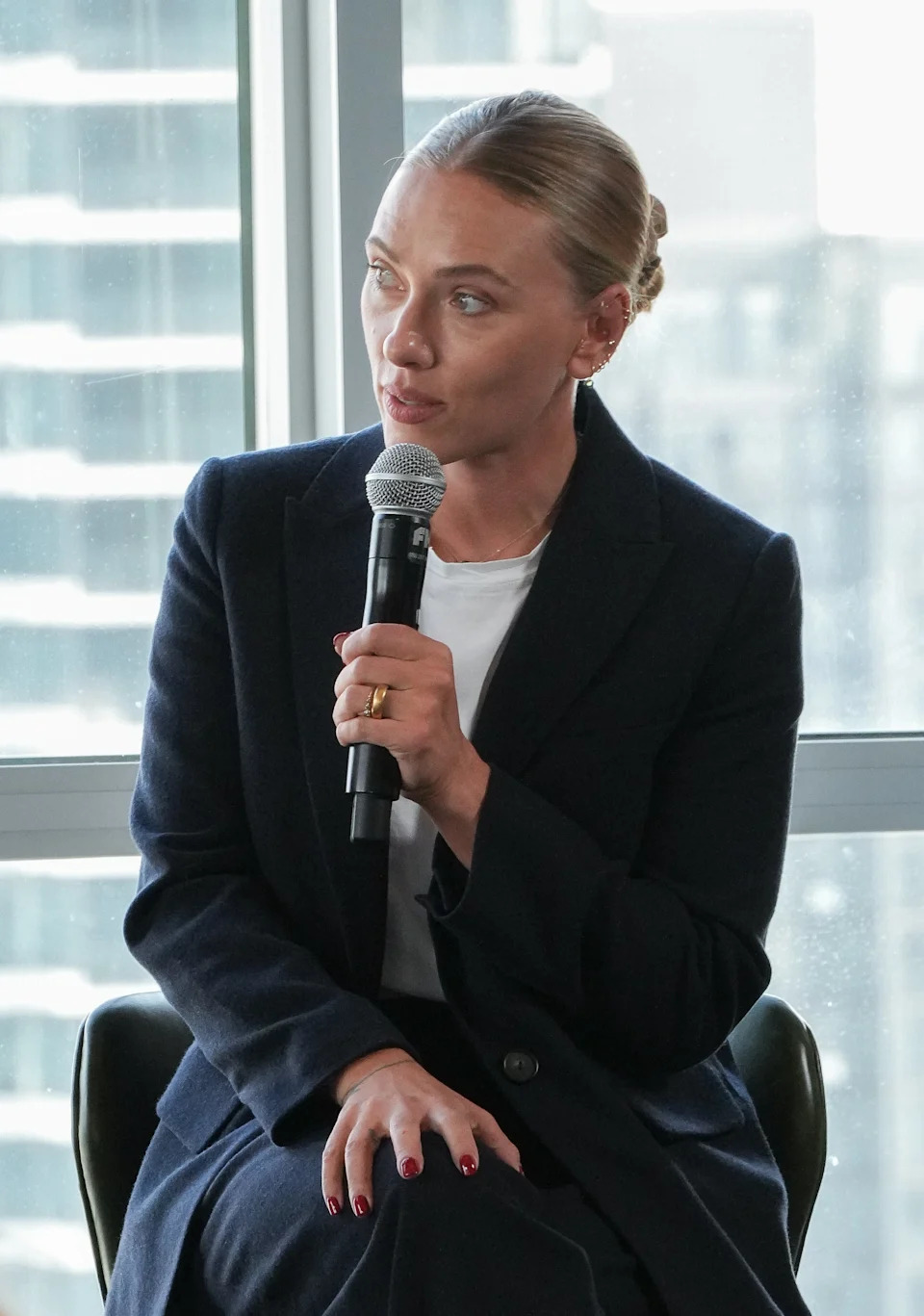 Scarlett speaking into a microphone at an indoor event