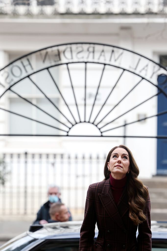 Catherine, Princess of Wales wears a tartan burgundy coat for a visit to The Royal Marsden Hospital