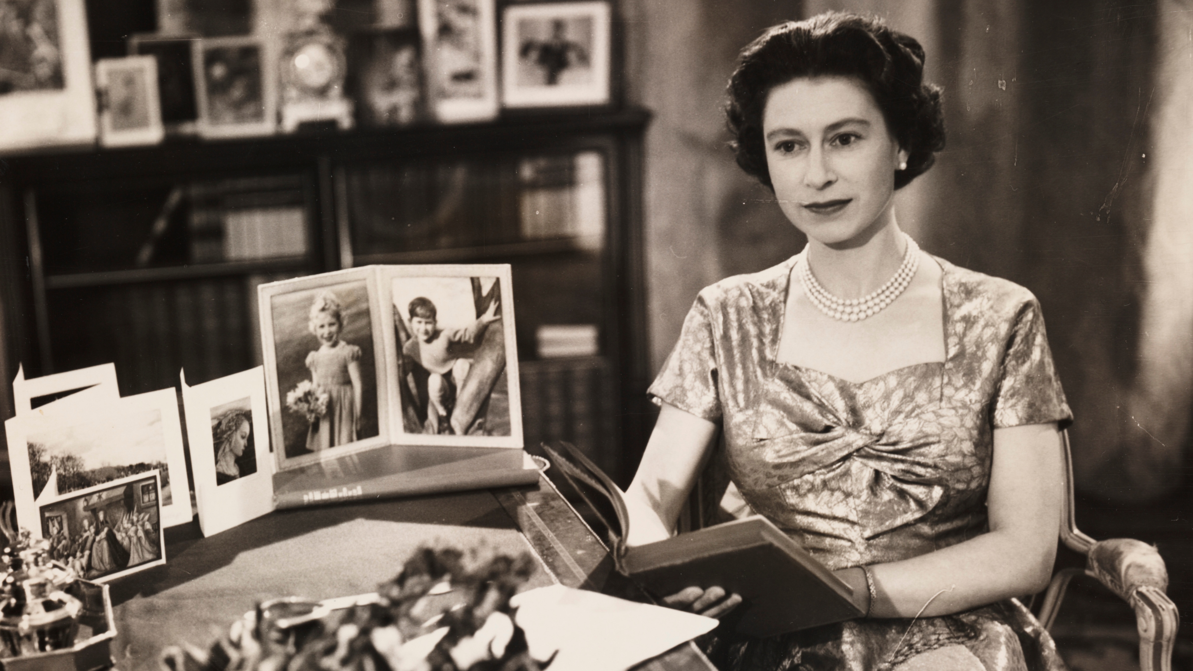 Queen Elizabeth II sits at her desk to make her Christmas broadcast, 1957