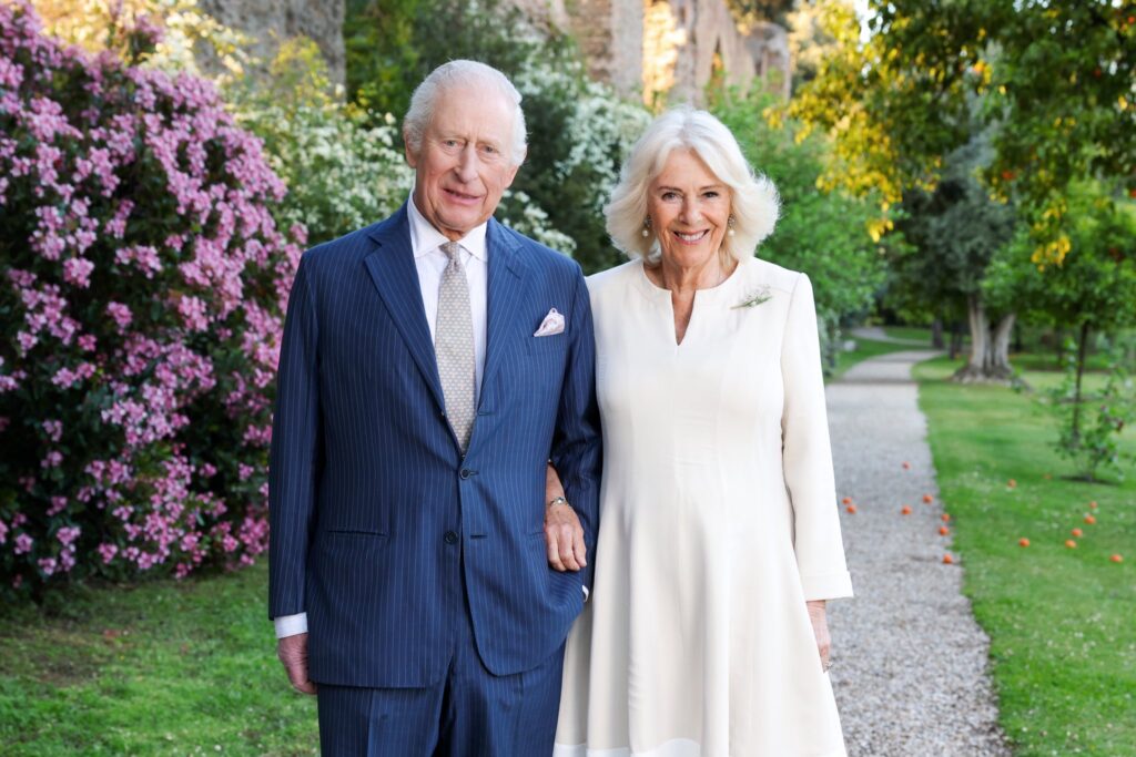 King Charles and Queen Camilla walk in a garden in Rome