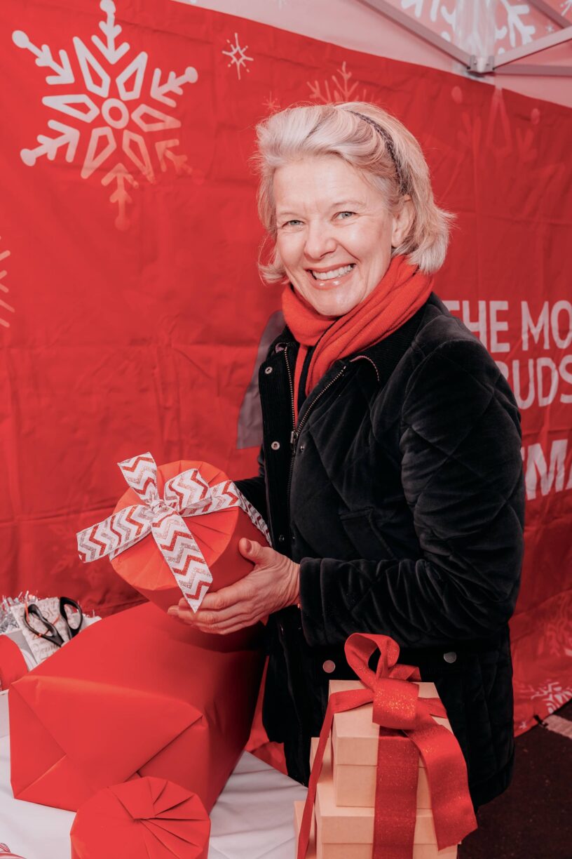 Festive cheer in full swing as expert Jane Means wraps gifts at Car‑istmas® drive‑through wrapping service