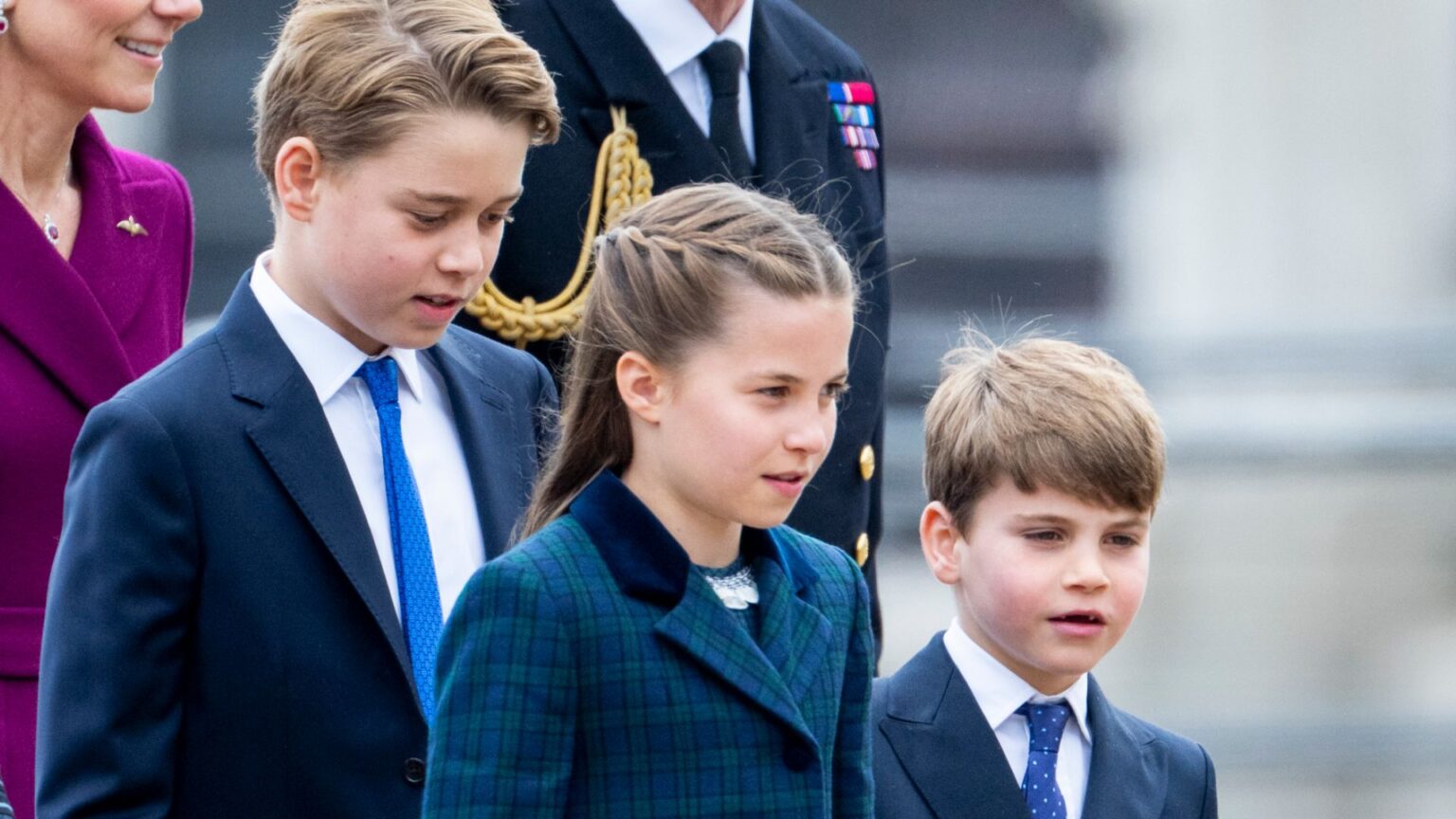 Expert Says Prince George Is Self-Assured, Louis Is at Ease Prince George and Prince Louis wear navy suits with royal blue ties and white shirts, while their sister Princess Charlotte walks between them wearing a dark green and navy checked coat
