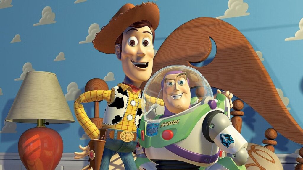 Why Pixar’s rules of storytelling are as relevant in 2026 as they were 15 years ago Pixar vs DreamWorks; a blue monster and a green monster on a stage, a cowboy and a space man toys