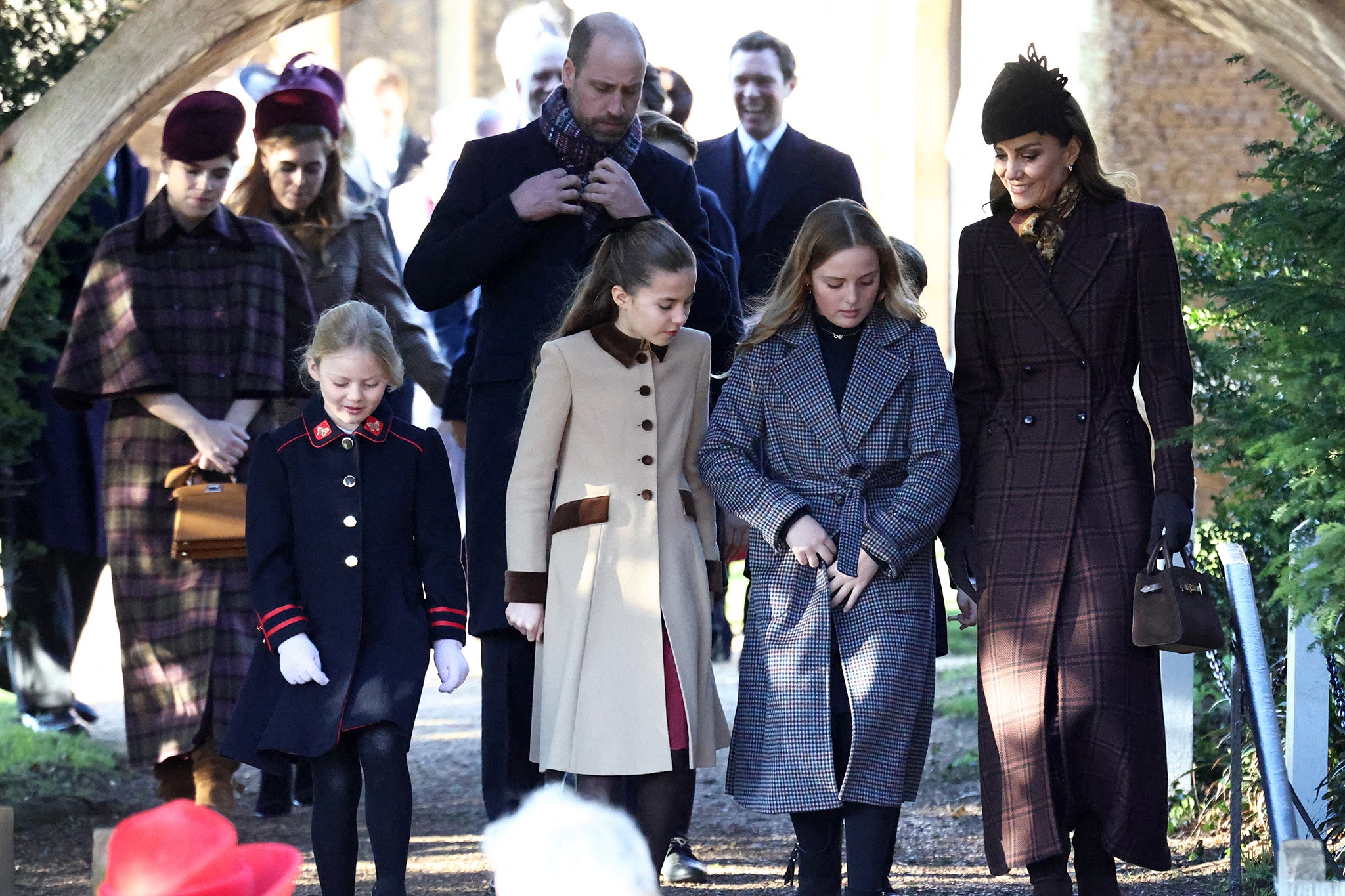 Princess Eugenie (L), Princess Beatrice (2L), Prince William, Prince of Wales (C), Princess Charlotte of Wales (C) and Catherine, Princess of Wales (R) leave after attending the Royal Family's traditional Christmas Day service at St Mary Magdalene Church