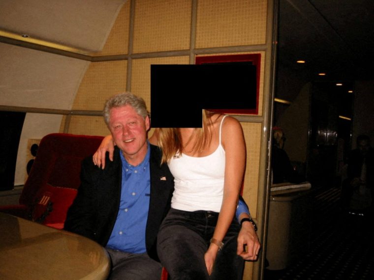 Former U.S. President Bill Clinton and a woman are seen in this image from the estate of late financier and convicted sex offender Jeffrey Epstein, released by the Department of Justice in Washington, D.C., U.S., on December 19, 2025. U.S. Justice Department/Handout via REUTERS THIS IMAGE HAS BEEN SUPPLIED BY A THIRD PARTY REDACTED AREAS FROM SOURCE. TPX IMAGES OF THE DAY THIS PICTURE WAS PROCESSED BY REUTERS TO ENHANCE QUALITY. AN UNPROCESSED VERSION HAS BEEN PROVIDED SEPARATELY.