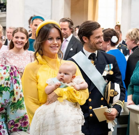 Princess Sofia carries her daughter, Princess Ines, through the royal chapel at the baby