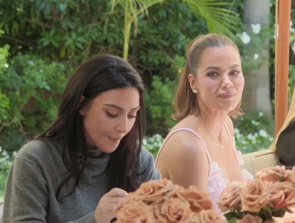 Kim and Khloé sitting outdoors