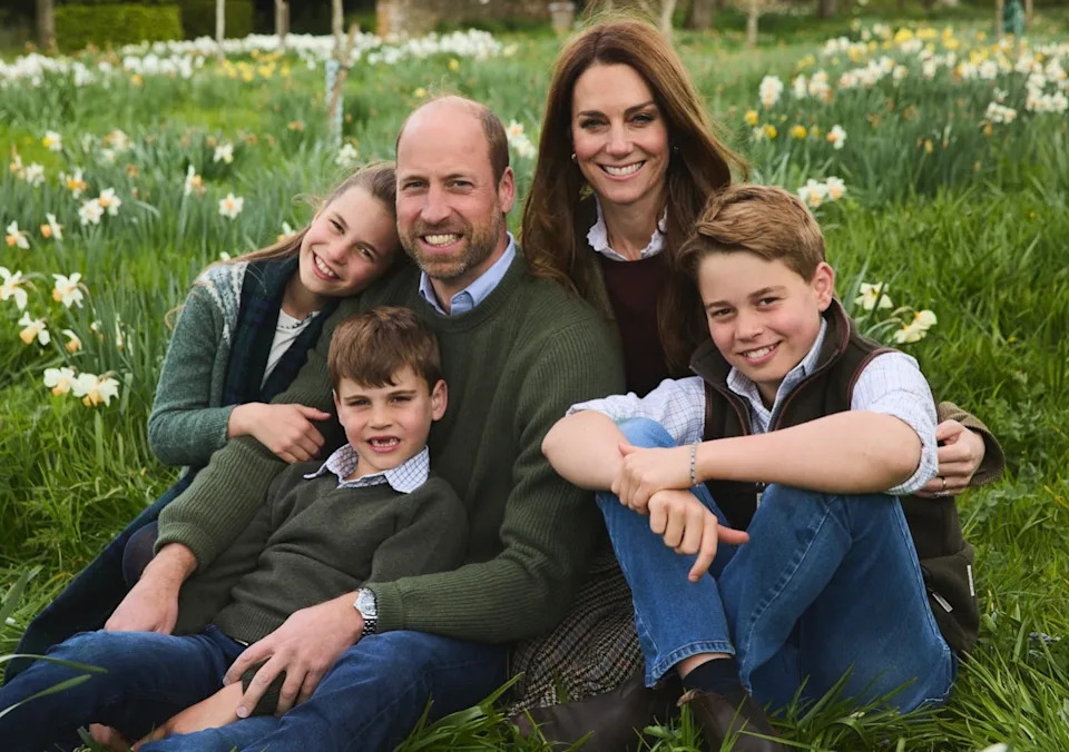 Prince William, Princess Kate, Princess Charlotte, Prince Louis and Prince George sitting in a field of flowers