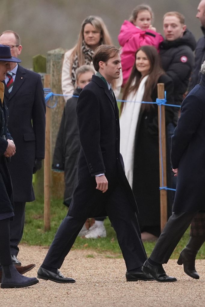 Charles Armstrong-Jones in black coat walking outside
