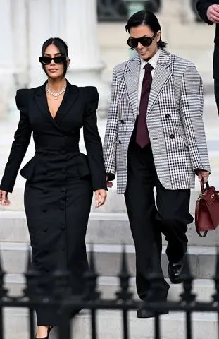 LEO VIGNAL/AFP via Getty Kim Kardashian leaves the Assize Court with her mother Kris Jenner on May 13, 2025 after testifying