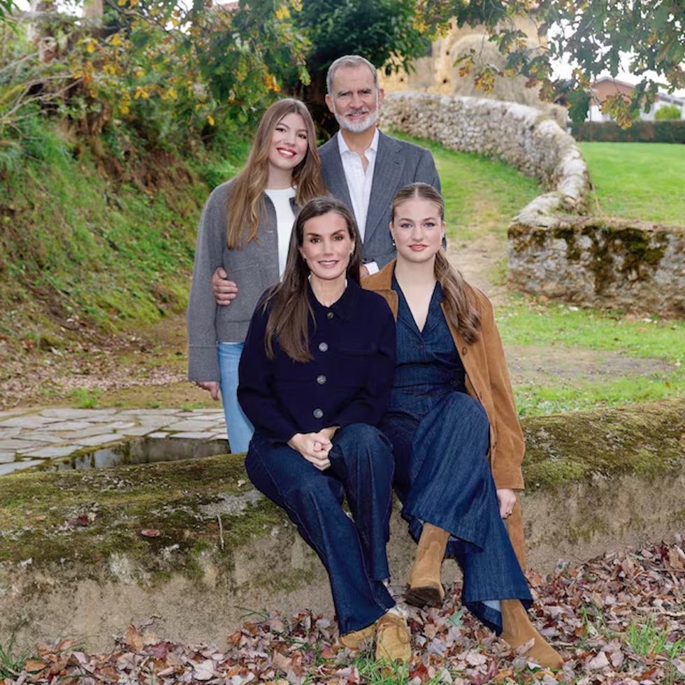 Group of four individuals posed outdoors in a natural setting.