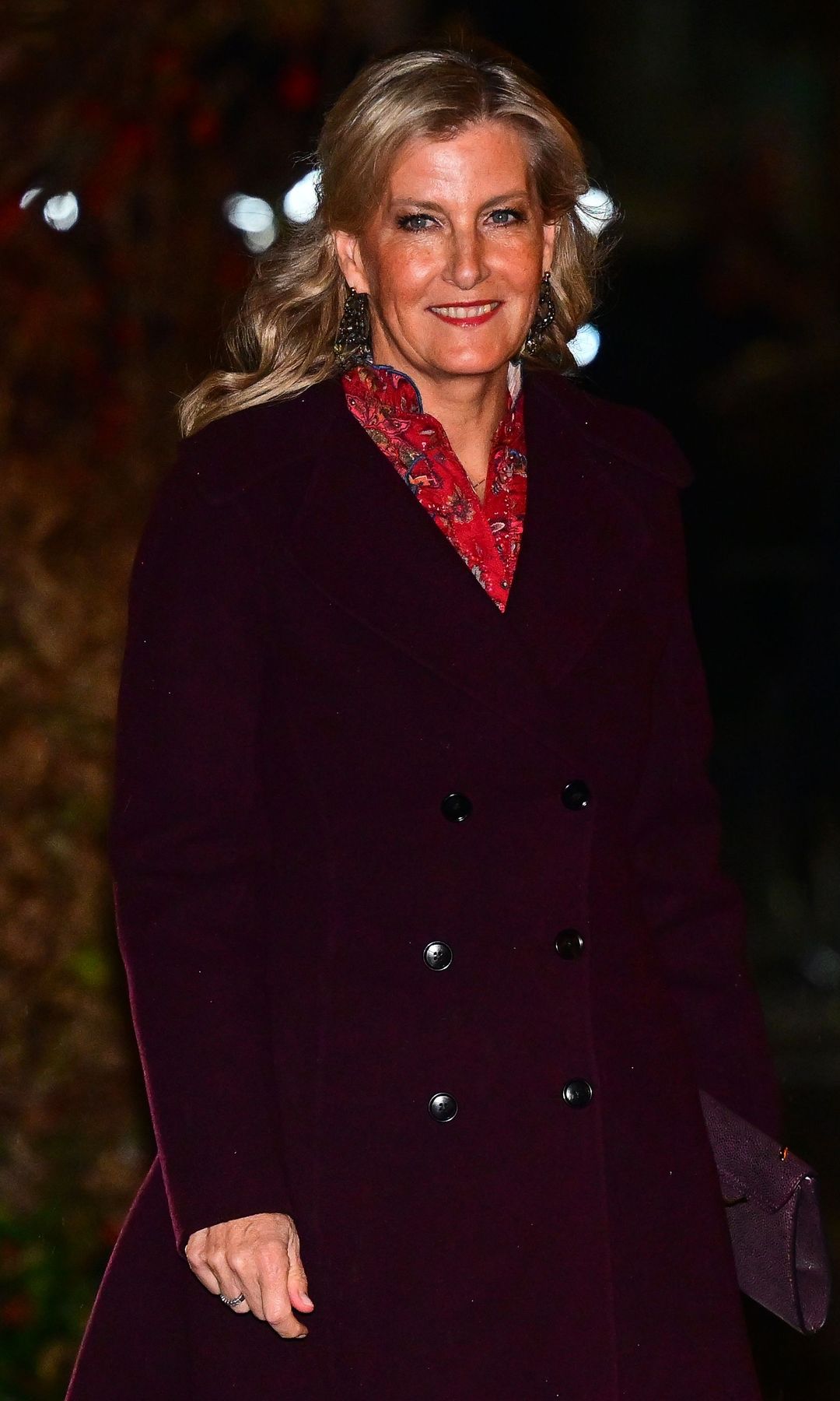 Duchess Sophie walking in a burgundy coat