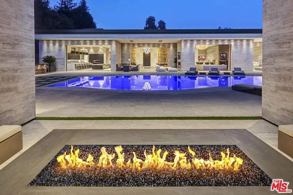 A fire pit and the pool at night at Kylie Jenner's California home in Holmby Hills