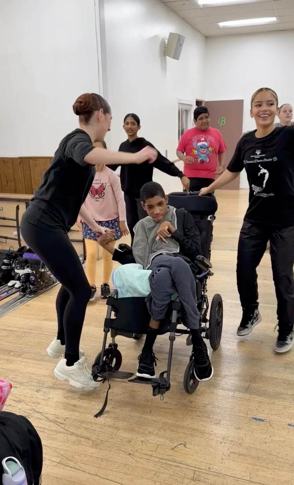 In one of the clips, dance instructors spun the 19-year-old around as he smiled in his specialized power wheelchair. Khloe Kardashian/Instagram