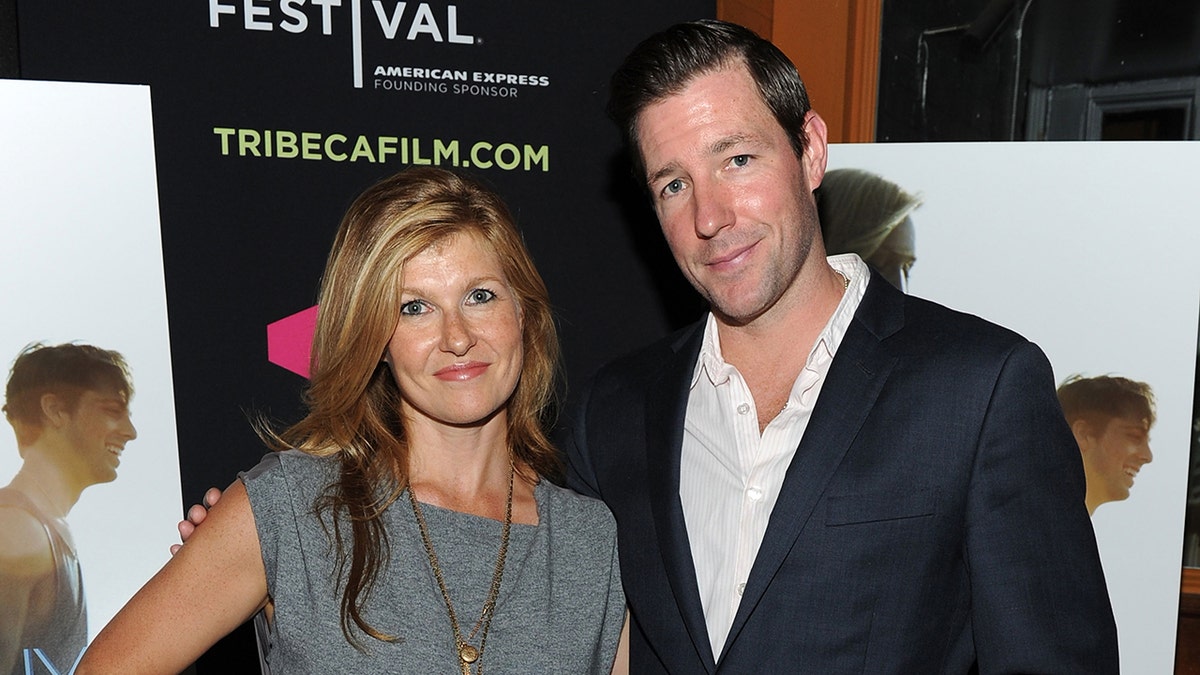 Ed Burns and Connie Britton standing side-by-side smiling during a movie premiere.